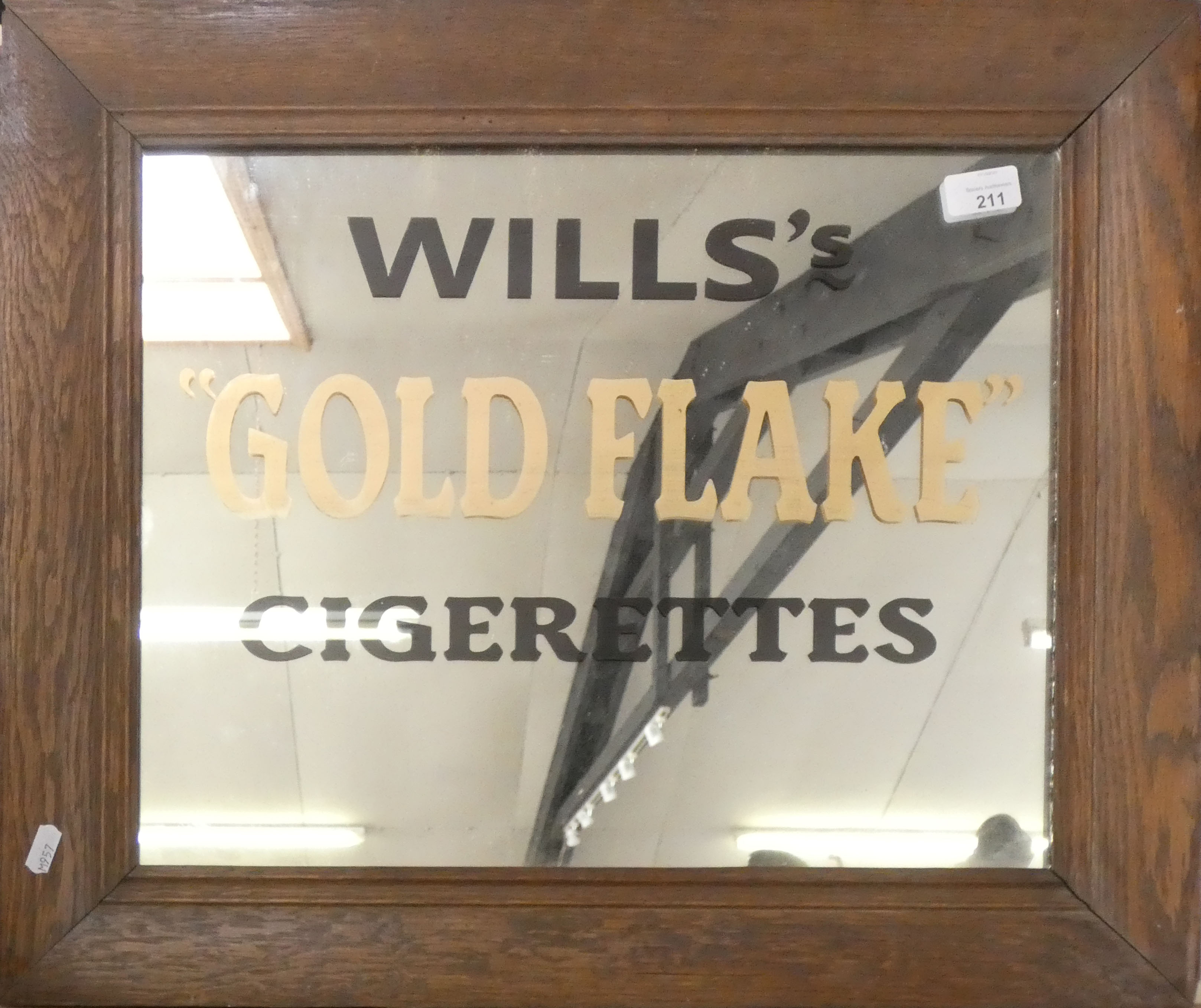 A rectangular oak framed mirror painted Wills Gold Flake Cigarettes, 52x62cm