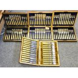 Four electroplated sets of twelve pairs of fish knives and forks, three with silver ferrules, cased
