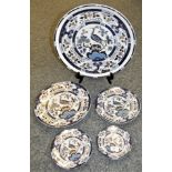 A set of five graduated Chinese blue and white plates and platters, decorated with peacocks and