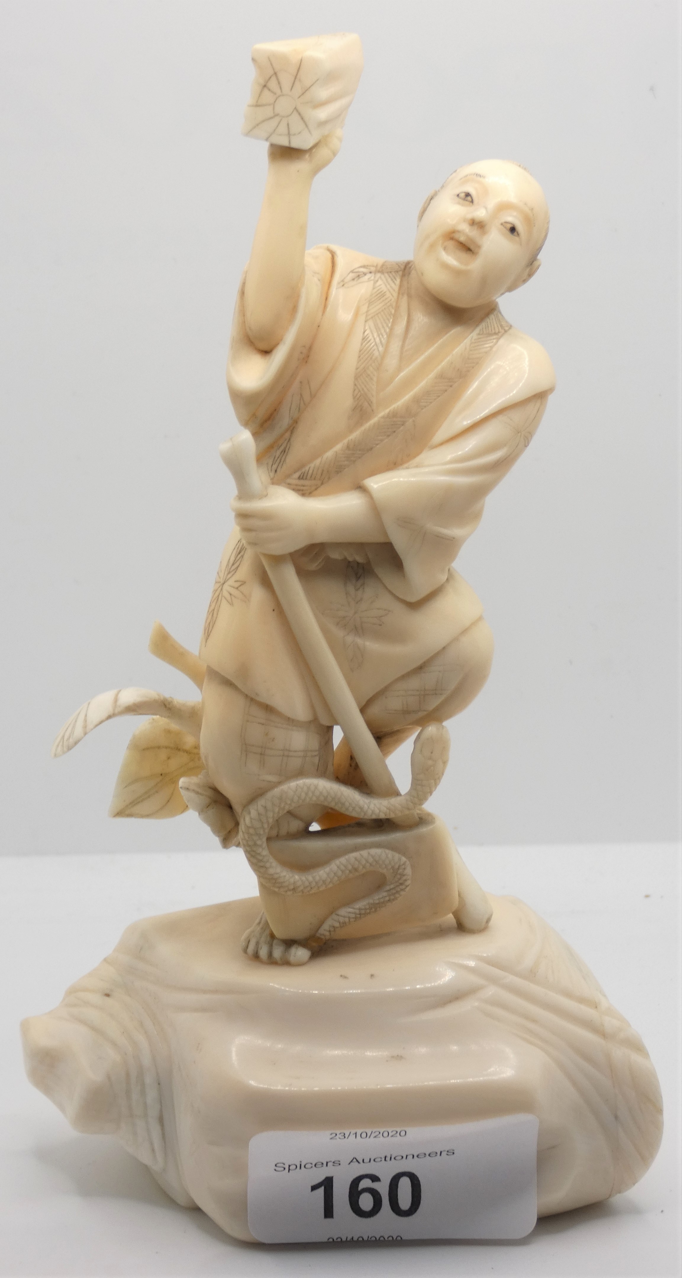 A Japanese ivory okimono of an axeman fighting a snake, 16cm