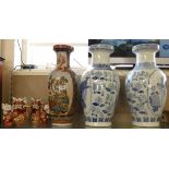 A pair of large decorative oriental blue and white vases, the two panels decorated with peacocks and