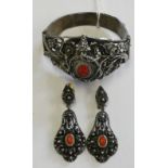 A low grade silver and coral filigree bracelet with matching ear pendants