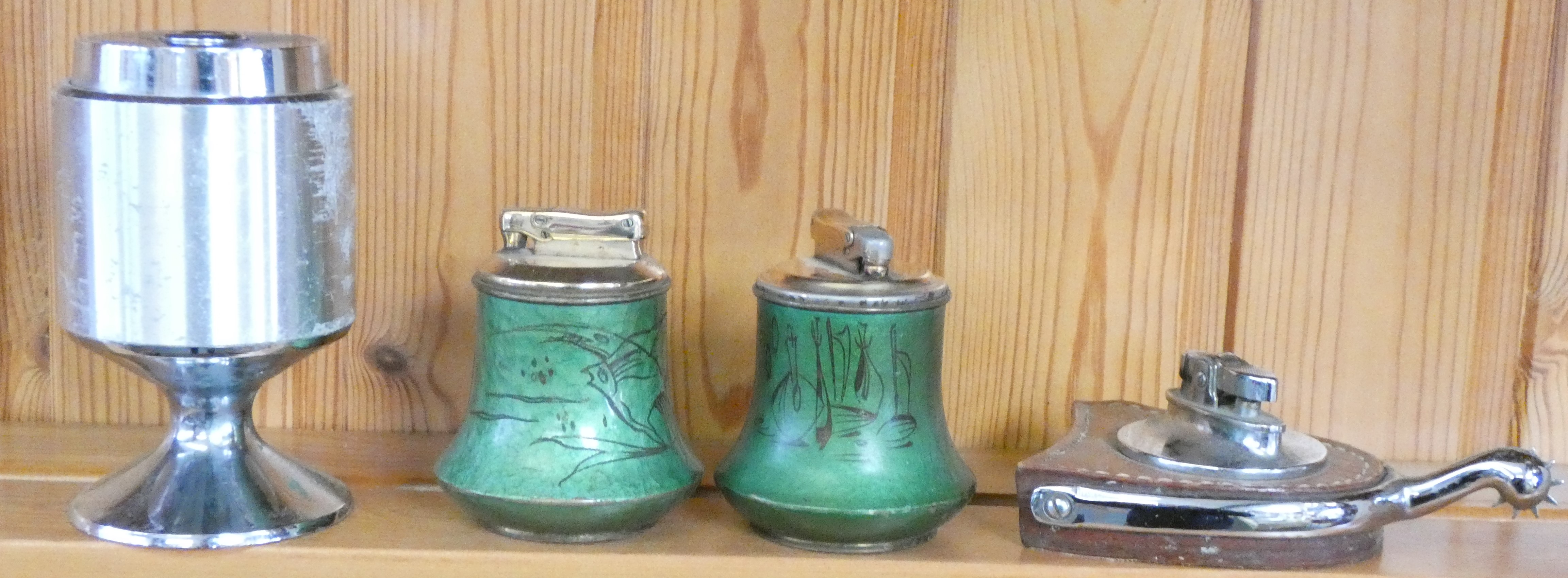 A Rolstar equestrian spur table lighter, a Colibri hammered enamel table lighter with fish