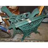Two pairs of green cast iron bench ends and a pair of cast iron table legs