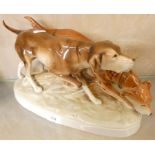 A mid-20th century Royal Dux porcelain figure group of two hunting dogs, height 19cm.