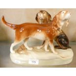 A mid-20th century Royal Dux porcelain figure group of two hunting dogs, height 20.5cm.