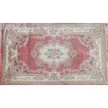A pair of famile rose Chinese rugs, with tassel ends, 270x185cm and a similar lighter example (3)