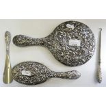 An embossed silver hand mirror Birmingham 1909, and three other silver items