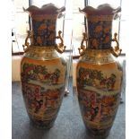 A large pair of chinese floor vases decorated with ladies and a horse outside of a house, gilt