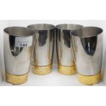 Stuart Devlin for Viners, a set of four stainless steel and gilt metal beakers