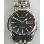A Seiko automatic wristwatch model 7526-01V0, with black dial and exposed movement, case