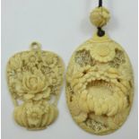 A Japanese Meiji period carved ivory pendant, depicting a chrysanthemum, 6.5 x 4.5 cm with bead to
