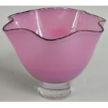 Gillies Jones of Rosedale, a purple glass bowl with crimped black rim on a short pedestal foot,