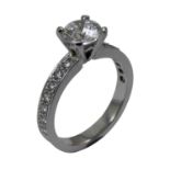 A platinum and diamond single stone ring, claw set with a brilliant cut stone, weighing 1.005cts,