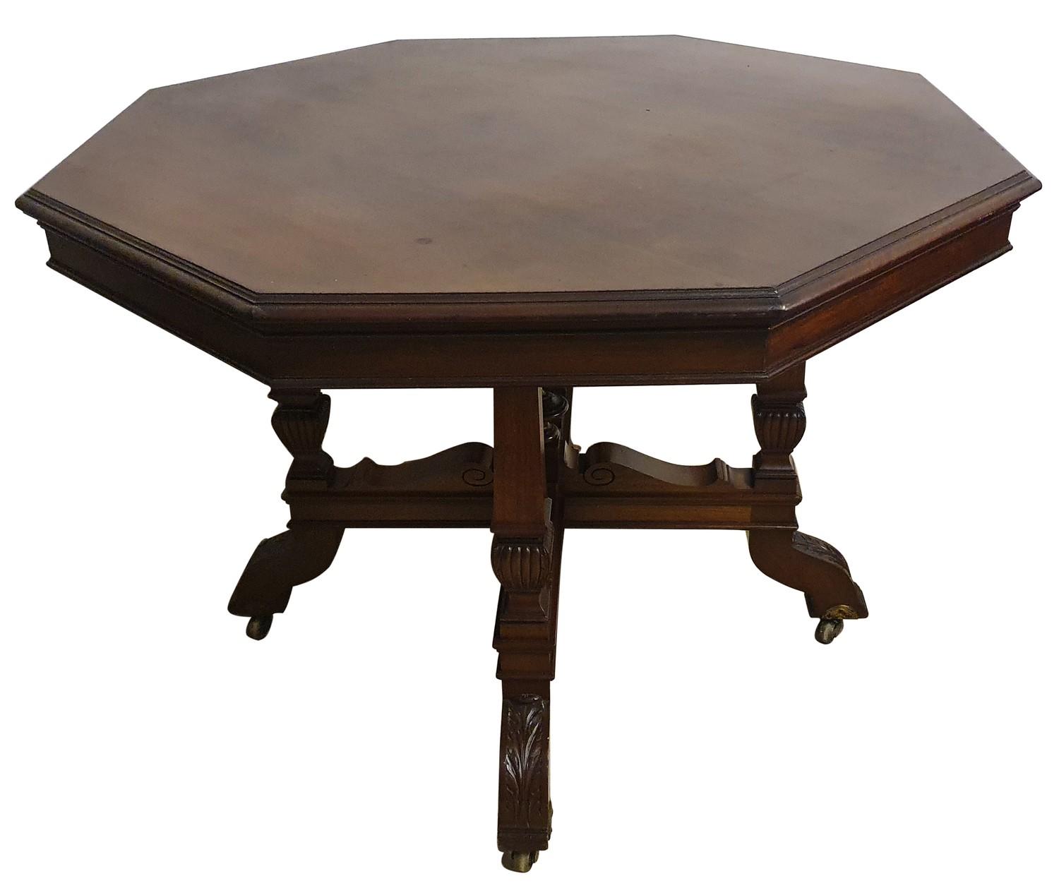 An Edwardian mahogany octagonal dining table, raised on four tapering supports with carved