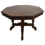 An Edwardian mahogany octagonal dining table, raised on four tapering supports with carved