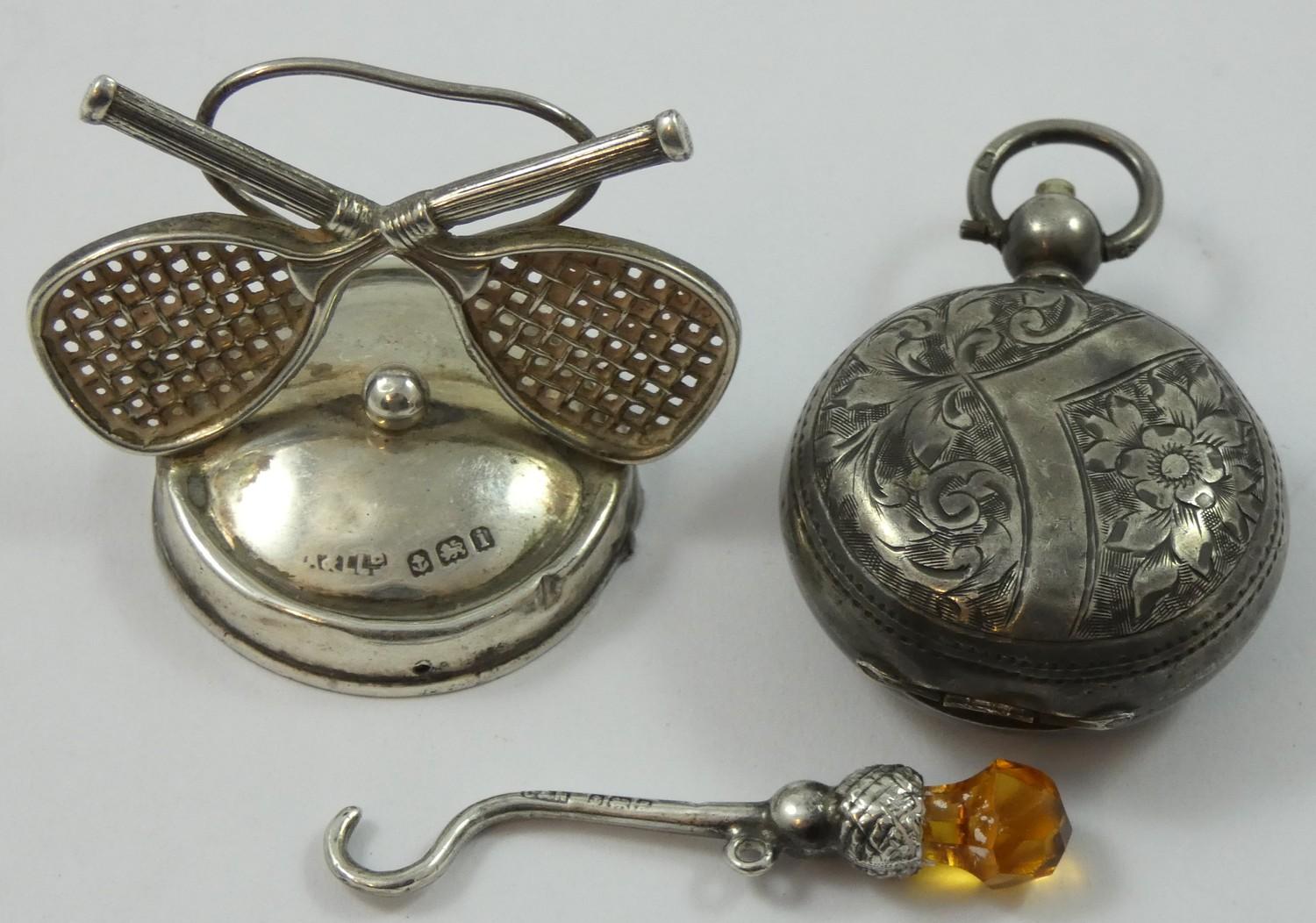 Of Tennis interest; an Edwardian silver menu holder, Birmingham 1908, with crossed racket and ball