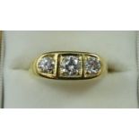 An 18ct gold three stone diamond ring, boat set with brilliant cut stones, total weight