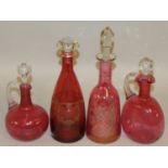 A group of four Victorian Cranberry glass decanters, all with stoppers, tallest 34cm (4).