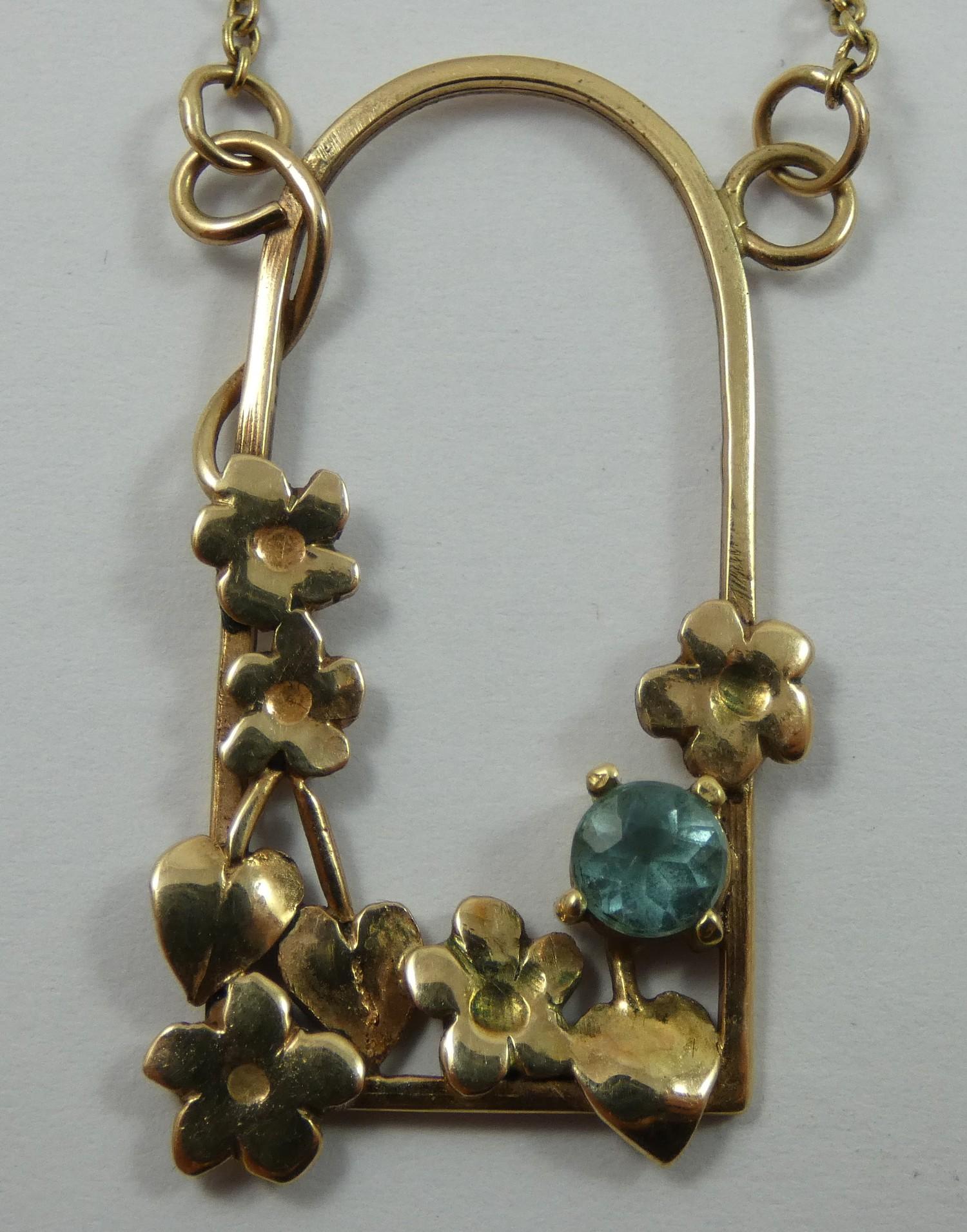 A 9ct gold and blue zircon pendant, in a floral mount, a similar bangle and pair of ear rings, gross