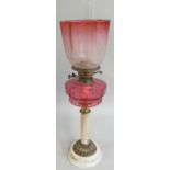 A late Victorian brass and glass oil lamp, with moulded ruby glass reservoir, acid etched ruby