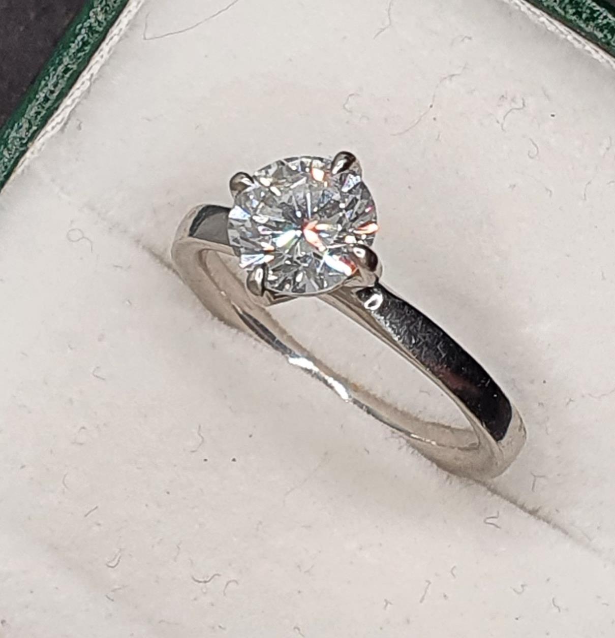 A platinum and diamond single stone diamond ring, four claw set with a brilliant cut stone