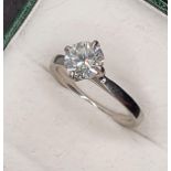 A platinum and diamond single stone diamond ring, four claw set with a brilliant cut stone