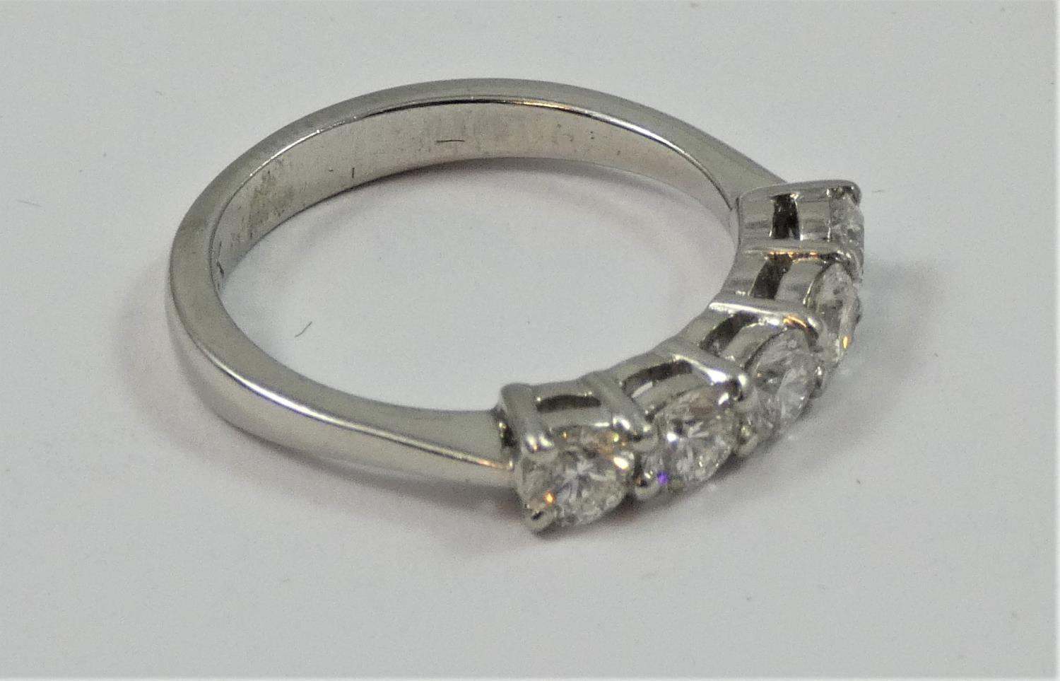 A platinum and diamond five stone ring, claw set with uniform brilliant cut stones, total weight