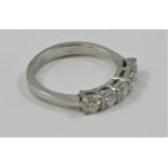 A platinum and diamond five stone ring, claw set with uniform brilliant cut stones, total weight