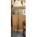 A brass standard lamp, with trefoil base, 122 cm.