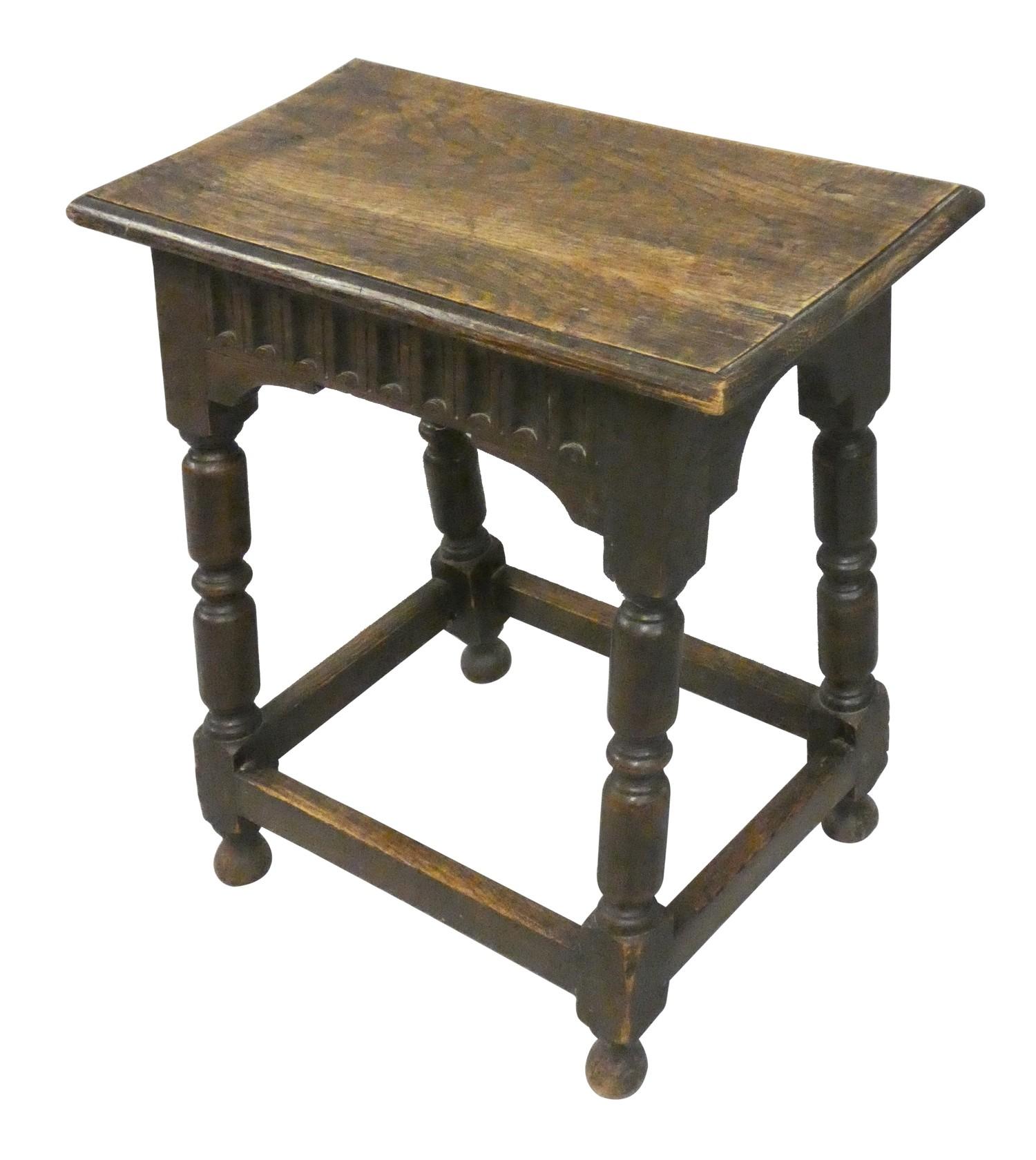 An Edwardian oak joint stool, with carved frieze and turned legs, 53 x 27 x 54 cm.