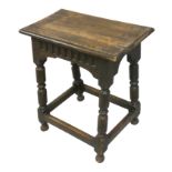 An Edwardian oak joint stool, with carved frieze and turned legs, 53 x 27 x 54 cm.