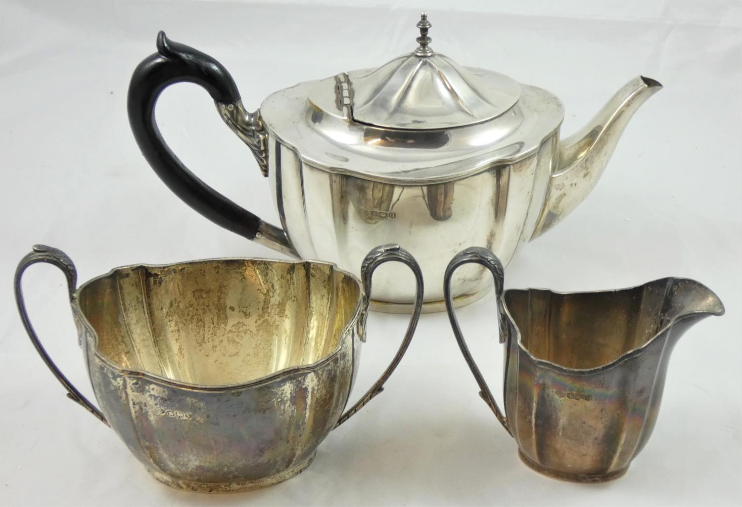 A silver three piece tea service, Sheffield 1937/38, of oval shaped form, comprising tea pot,