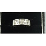 A platinum and diamond two row ring, channel set with graduated brilliant cuts stones, total