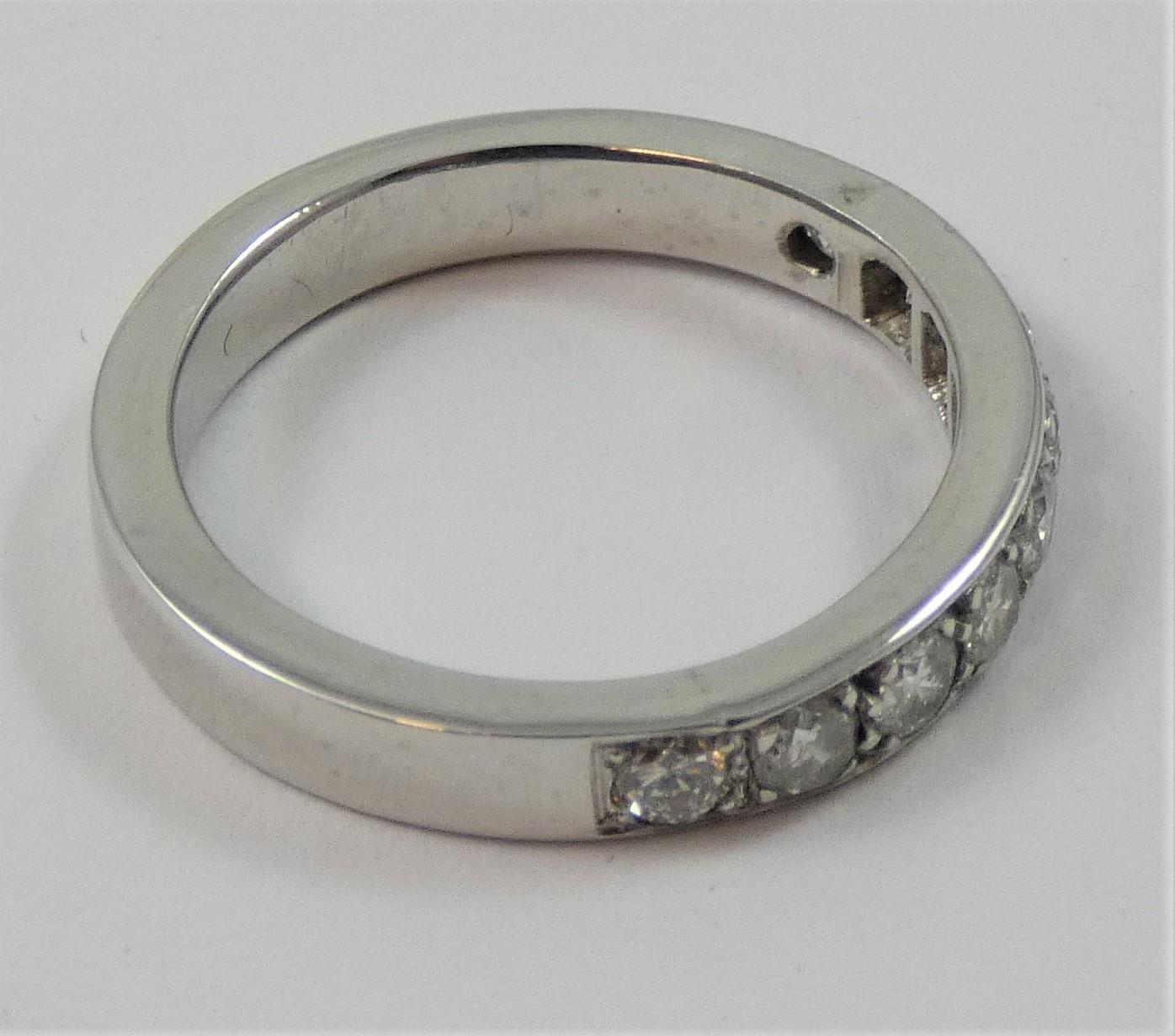 A white metal, probably platinum and diamond half eternity ring, set with nine brilliant cut stones, - Image 2 of 2