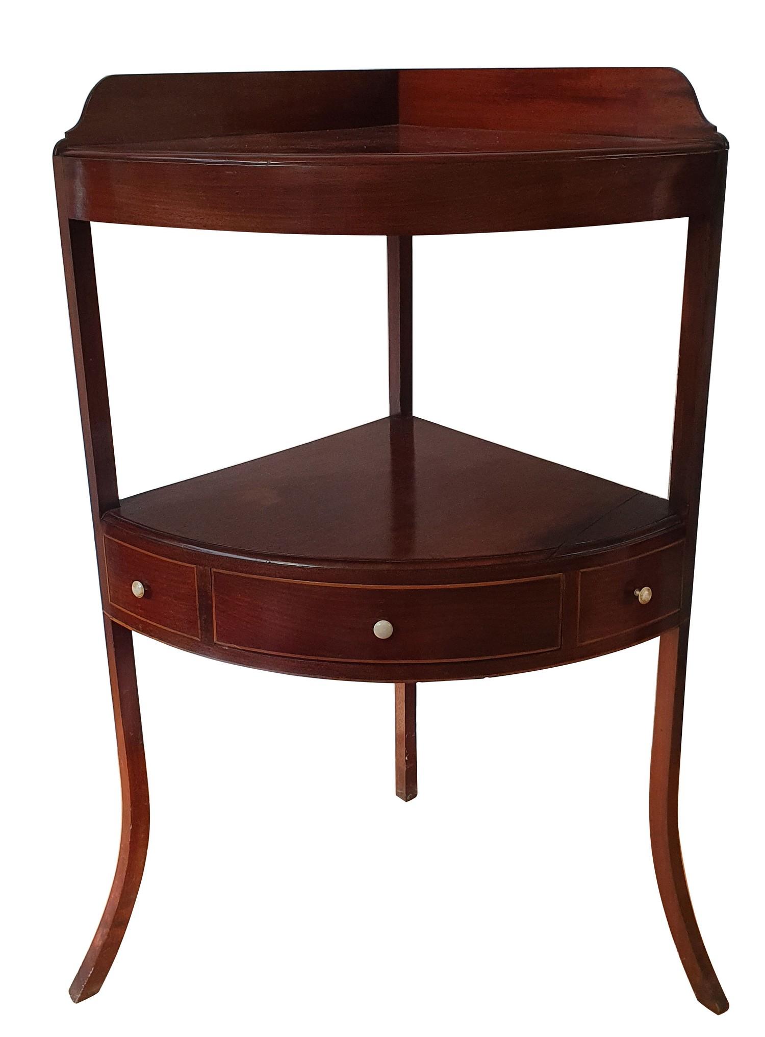 A 19th century mahogany corner washstand, the lower shelf with central drawer flanked by dummy