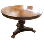 A Victorian mahogany tilt top circular dining table, raised on a baluster column with trefoil legs