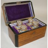 A Victorian mahogany cased perfume box, opening to reveal four small gilt decorated bottles, 18 x 11