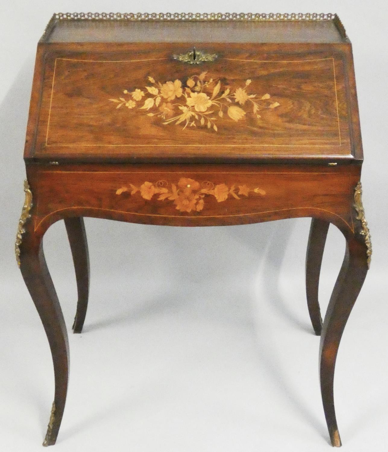 An Edwardian rosewood and inlaid Bonheur du Jour, the fall front with floral inlay, opening to