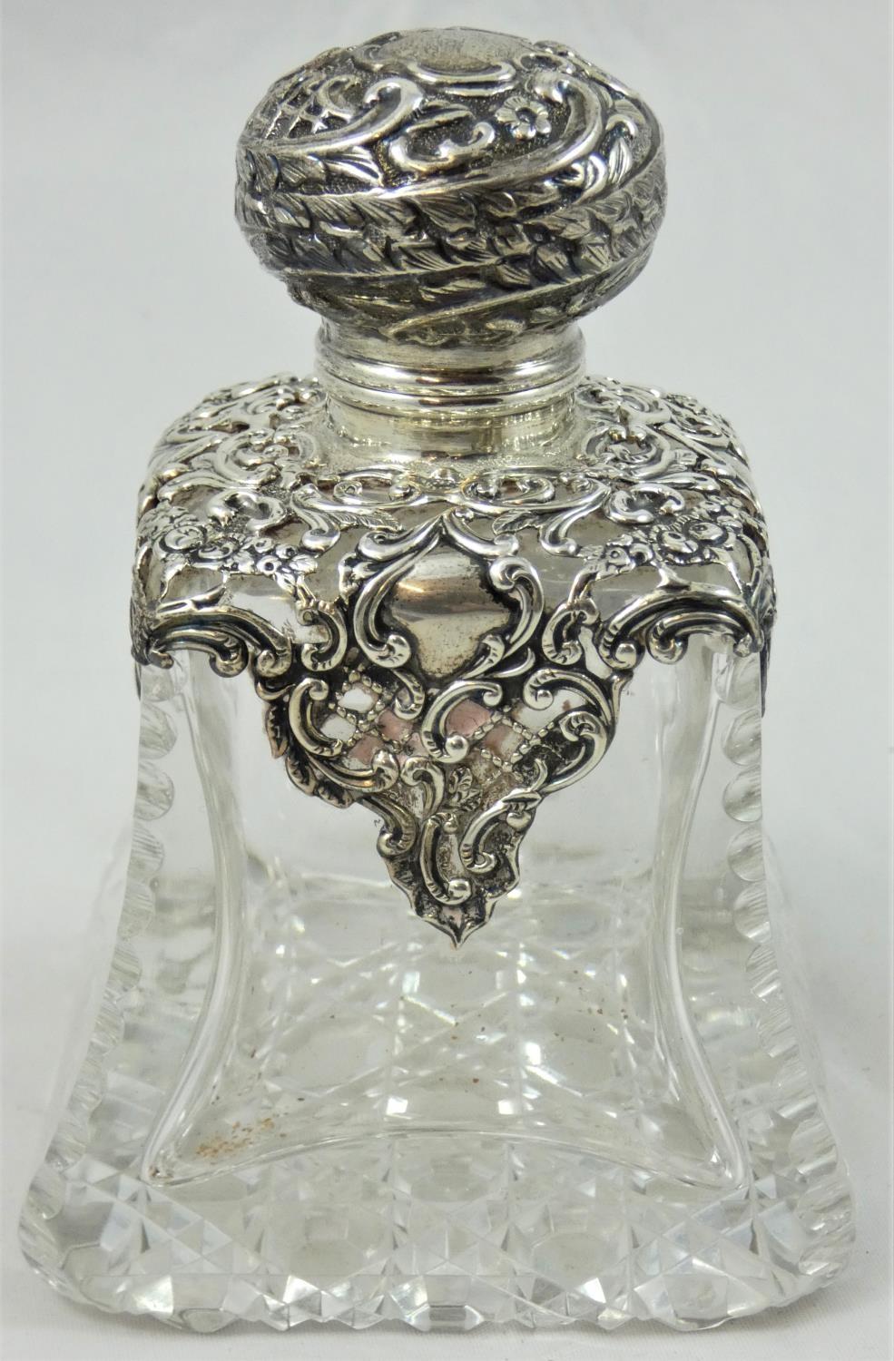 A Victorian cut glass and silver mounted scent bottle, Birmingham 1897, the hinged cover to a