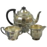 A silver three piece tea service, Sheffield 1925, of circular panelled form, comprising; tea pot,