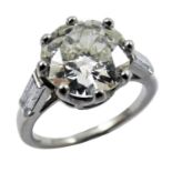 An Art Deco French platinum single stone diamond ring, claw set with an old brilliant cut stone,