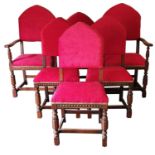 An Edwardian set of five carved oak dining chairs, with arched upholstered backs and turned legs,
