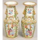 A pair of 19th century Chinese famile verte vases, decorated with figures and birds, with gilt
