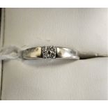 An 18ct white gold and diamond dress ring, (hallmark erased), set with four brilliant cut stones,