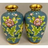 A Japanese pair of cloisonné baluster vases, decorated with a bird on foliage, pale blue background,