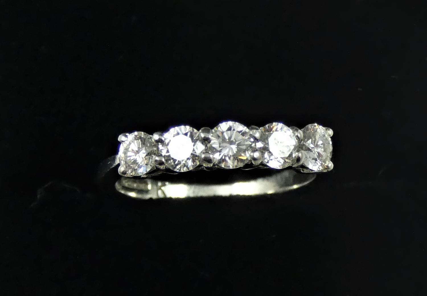 A platinum and diamond five stone ring, claw set with uniform brilliant cut stones, total weight - Image 2 of 2