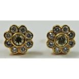 A pair of yellow gold , fancy yellow and white diamond cluster earstuds, the central stone of good