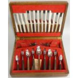 A Thomas Cork & Son stainless steel and rosewood canteen of cutlery for six place settings, mid 20th