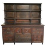 An Edwardian oak two rack dresser, the base with central two door cupboard over two drawers, flanked
